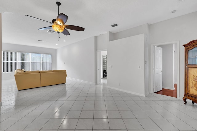 unfurnished living room featuring ceiling fan and light tile patterned floors