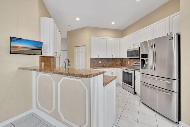 kitchen featuring kitchen peninsula, appliances with stainless steel finishes, and white cabinets