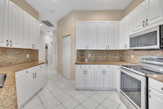 kitchen featuring white cabinets, stainless steel electric range oven, light stone counters, and backsplash