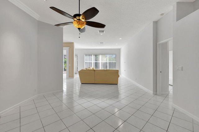 unfurnished living room featuring a textured ceiling, ceiling fan, and light tile patterned flooring