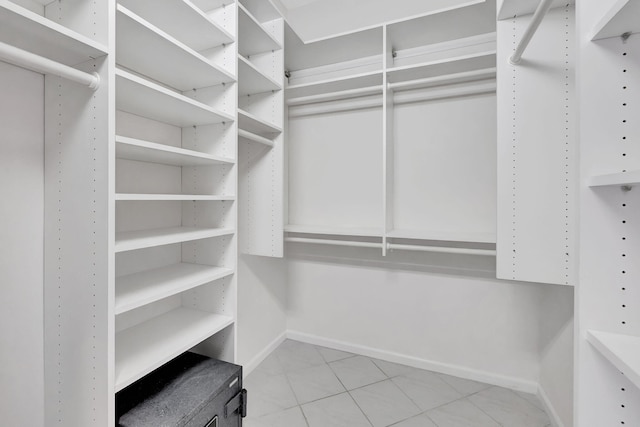 spacious closet with light tile patterned flooring