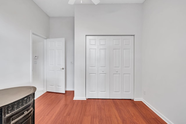 bedroom featuring ceiling fan, a closet, and light hardwood / wood-style flooring