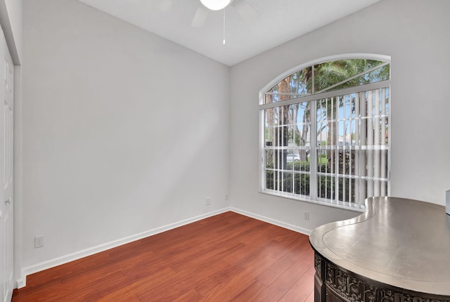 unfurnished dining area with hardwood / wood-style floors and ceiling fan