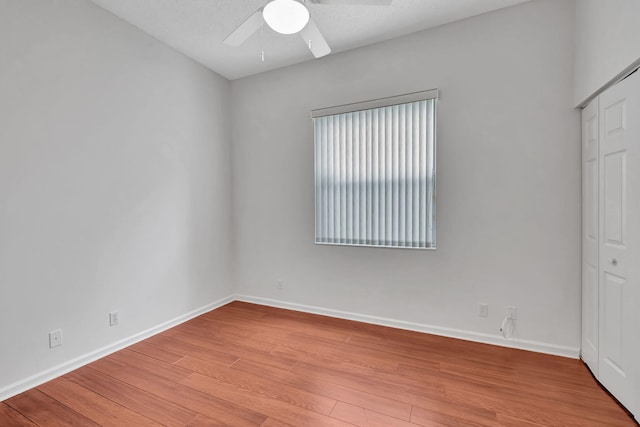 unfurnished bedroom featuring a textured ceiling, light hardwood / wood-style floors, ceiling fan, and a closet