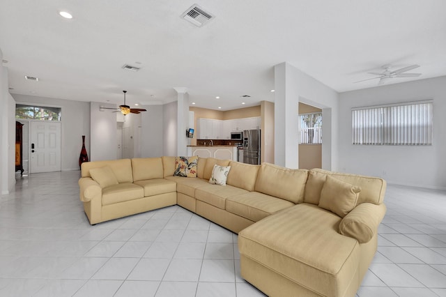 living room with ceiling fan and light tile patterned floors