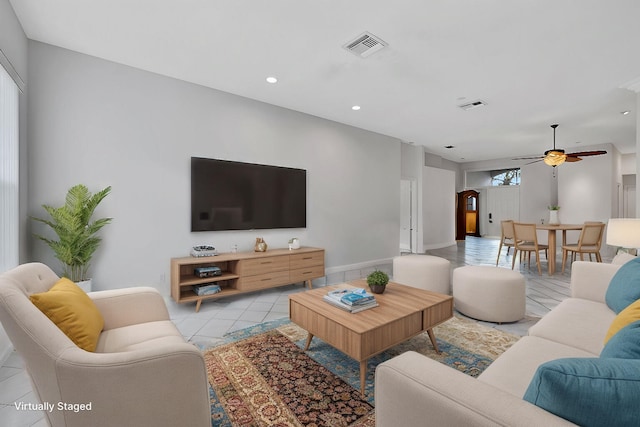 living room featuring ceiling fan and light tile patterned floors