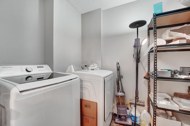 washroom with independent washer and dryer and a textured ceiling