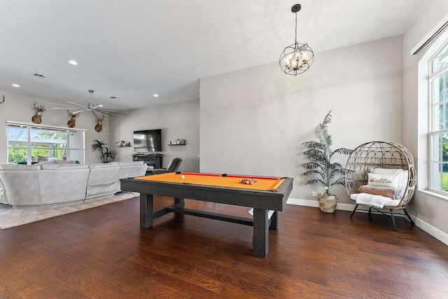 playroom featuring dark hardwood / wood-style floors, an inviting chandelier, a healthy amount of sunlight, and billiards