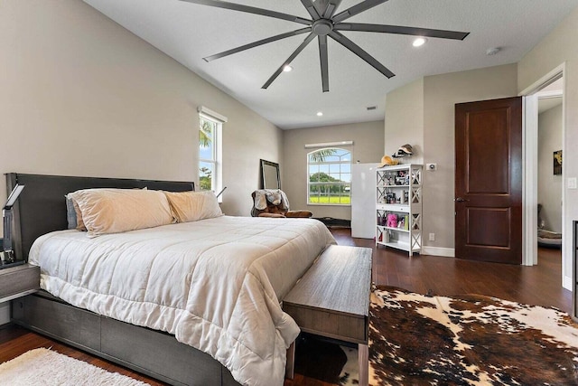 bedroom featuring a textured ceiling, dark wood-type flooring, and ceiling fan