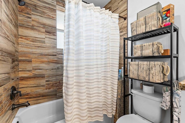 bathroom featuring shower / tub combo with curtain, wooden walls, and toilet