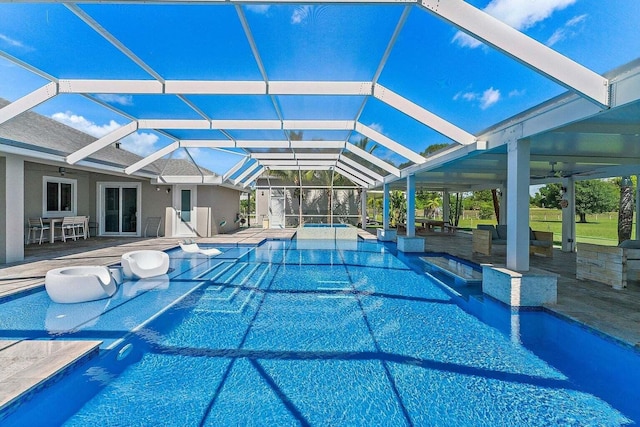 view of pool with a patio and glass enclosure