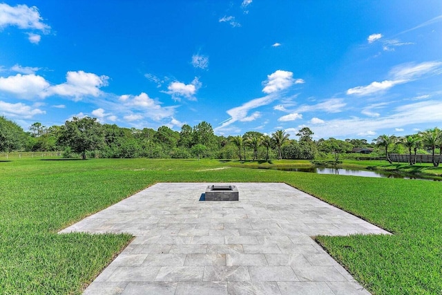 view of patio featuring a water view and a fire pit