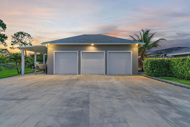 view of garage at dusk