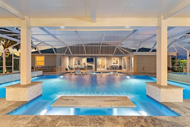 view of swimming pool with a hot tub, glass enclosure, pool water feature, and a patio area