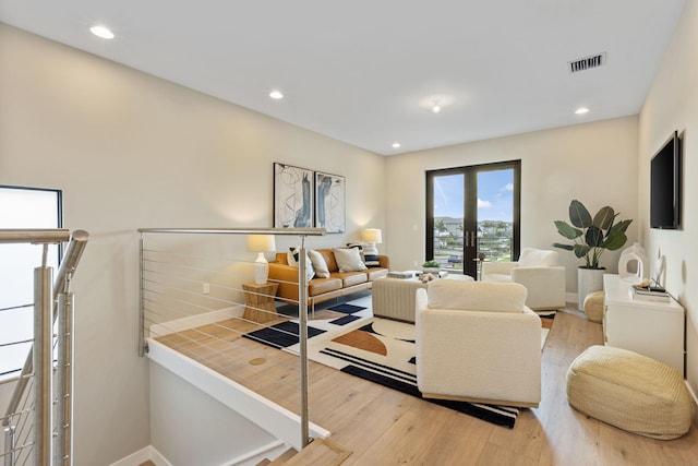 living room featuring light wood-type flooring and french doors