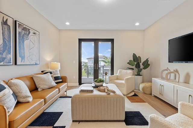 living room with french doors and light hardwood / wood-style floors