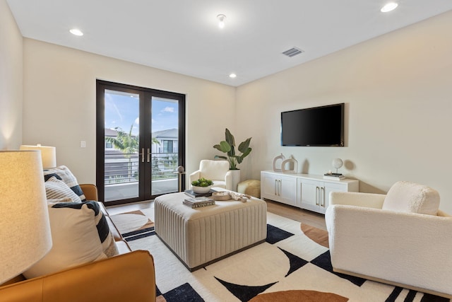 living room with french doors and light hardwood / wood-style floors