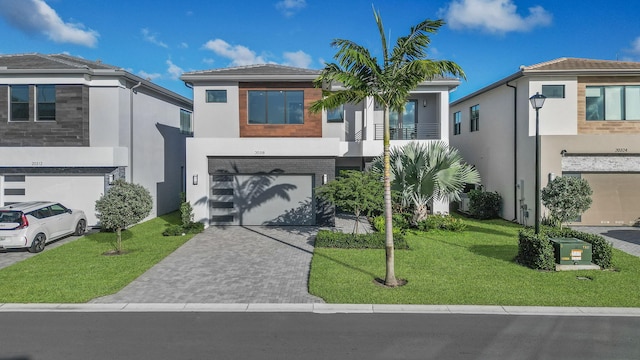 view of front of house with a garage and a front lawn