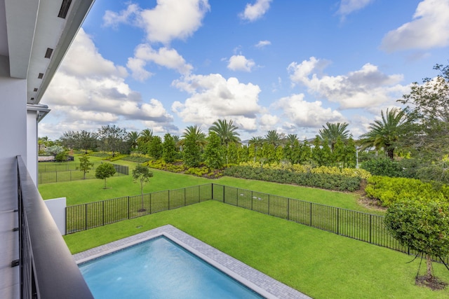 view of pool with a lawn