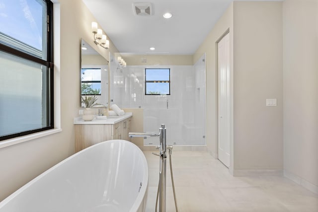 bathroom with tile patterned flooring, vanity, and shower with separate bathtub