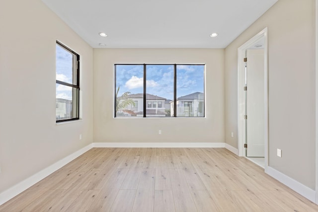 unfurnished room featuring light hardwood / wood-style flooring and a healthy amount of sunlight