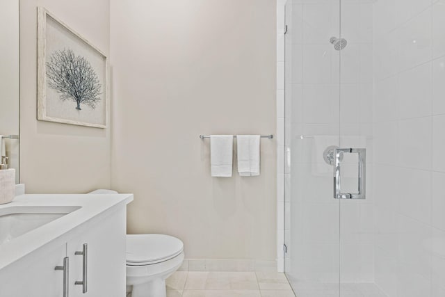 bathroom featuring tile patterned flooring, vanity, toilet, and a shower with shower door