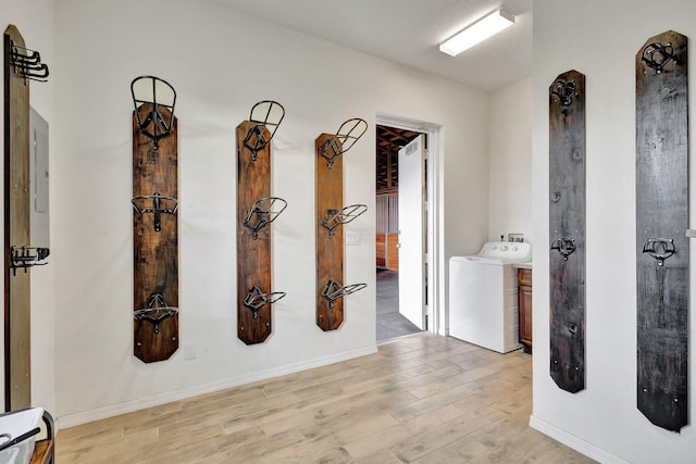 corridor featuring light wood-type flooring and washer / clothes dryer