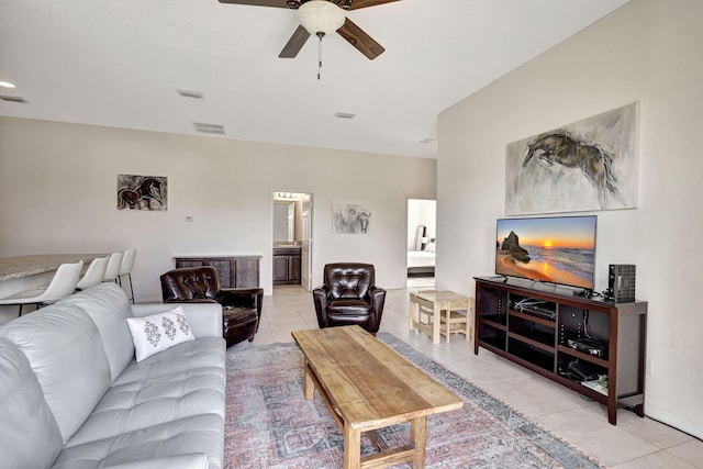 living room with ceiling fan and light tile patterned floors