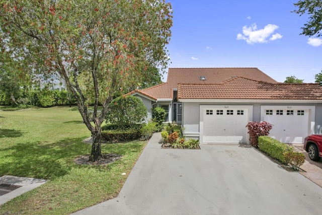 view of front facade with a front yard and a garage