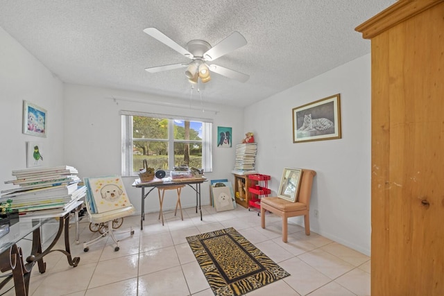 home office with ceiling fan, light tile patterned flooring, and a textured ceiling