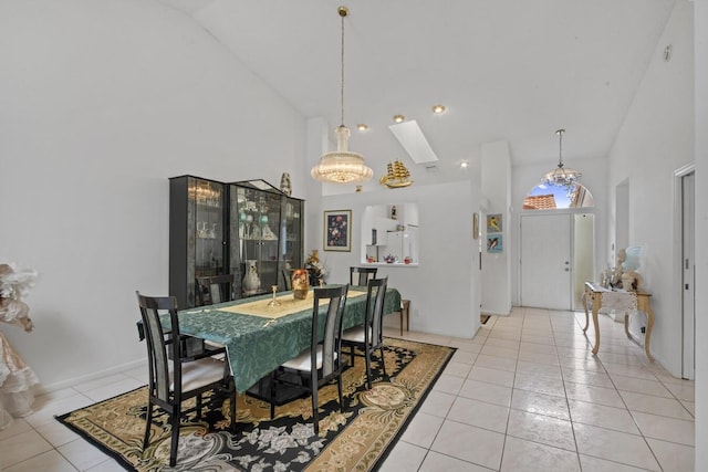 tiled dining area with an inviting chandelier and high vaulted ceiling