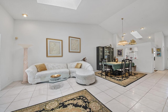 living room with vaulted ceiling with skylight and light tile patterned flooring