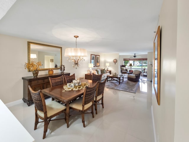 dining room with ceiling fan with notable chandelier