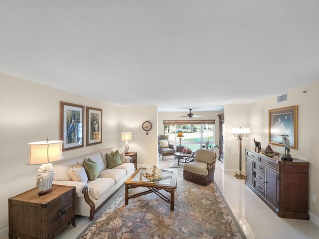 tiled living room with ceiling fan