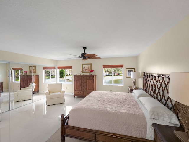 bedroom featuring multiple windows and ceiling fan