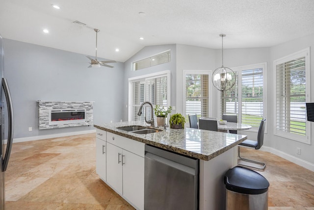 kitchen featuring white cabinetry, sink, dishwasher, vaulted ceiling, and a center island with sink