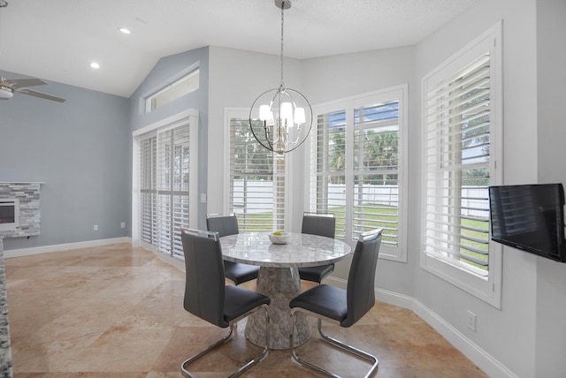 dining space with a textured ceiling, ceiling fan with notable chandelier, and lofted ceiling