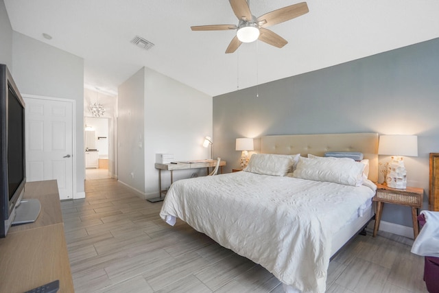 bedroom featuring ceiling fan with notable chandelier and vaulted ceiling