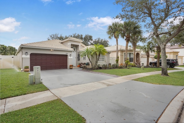 view of front of home with a front lawn and a garage