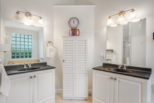 bathroom featuring tile patterned flooring, vanity, and an enclosed shower