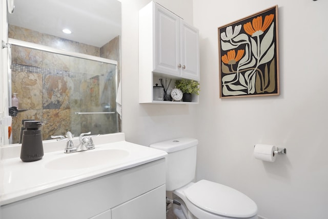 bathroom with vanity, an enclosed shower, and toilet