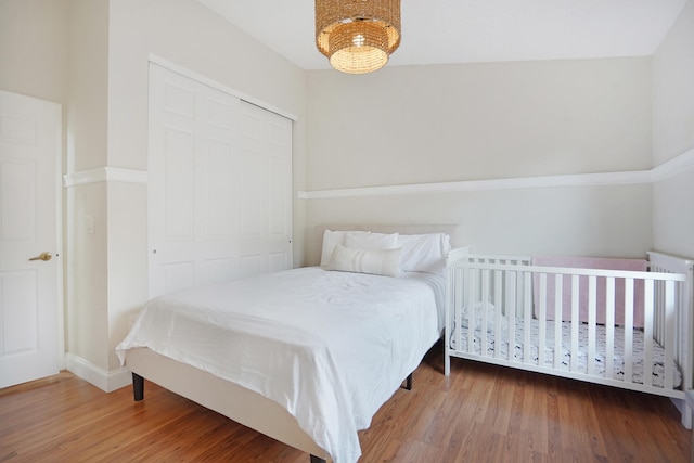 bedroom featuring hardwood / wood-style flooring and a closet