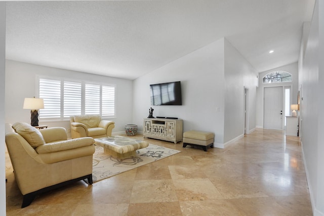 living room with a textured ceiling and vaulted ceiling