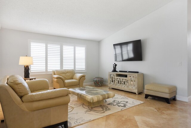 living room featuring a textured ceiling and lofted ceiling