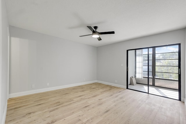 unfurnished room with a textured ceiling, light hardwood / wood-style floors, and ceiling fan