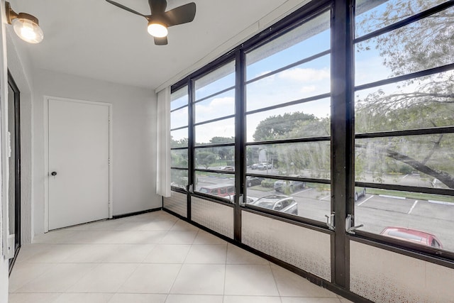 empty room with ceiling fan and light tile patterned flooring