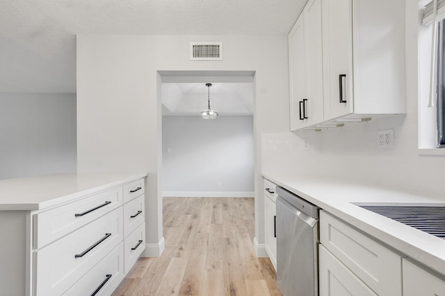 kitchen with white cabinetry, light hardwood / wood-style flooring, stainless steel dishwasher, pendant lighting, and a textured ceiling