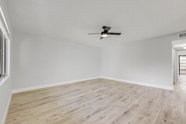 spare room featuring ceiling fan and light hardwood / wood-style floors