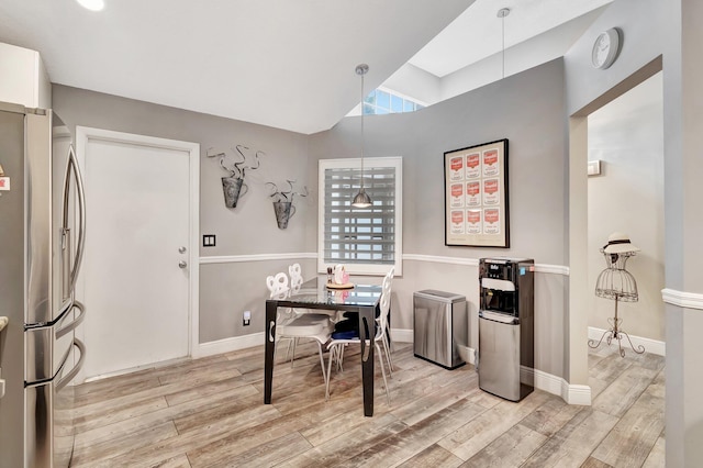 office area featuring light hardwood / wood-style floors and vaulted ceiling