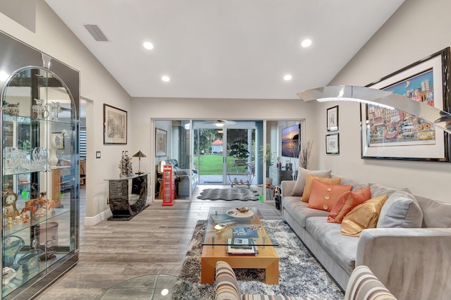 living room with light hardwood / wood-style flooring and lofted ceiling